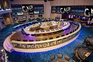 The Gallery Bar. Book. Games at Ocean Casino Resort interior main bar seating and table games with wall of led tvs.