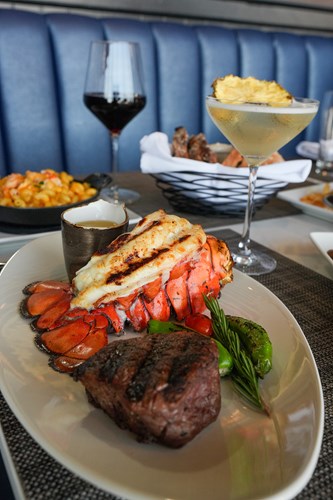 Dinner setting of steak, lobster, sides and libations.