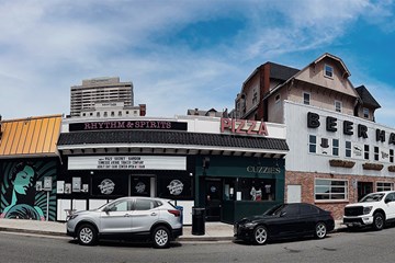 Street view of Tennessee Avenue establishments Bar 32 Chocolate, Rythm & Spirits, Cuzzies Pizzeria, and Tennessee Avenue Beer Hall