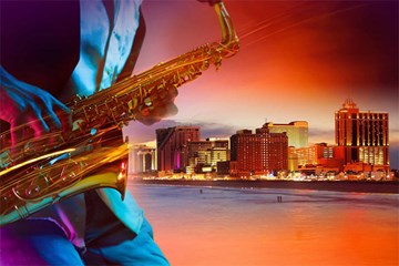 Saxophone player juxtaposed on skyline of Atlantic City at dusk.