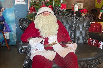 Bar 32 Santa Claus Hanging seated on a decorative chair on Tennessee Avenue in Atlantic City.