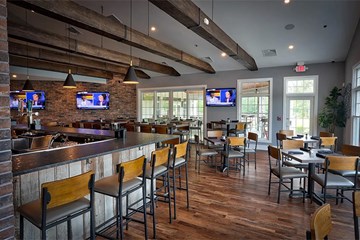 Harbor Pines Roost Pub and Grill interior bar area and table seating.